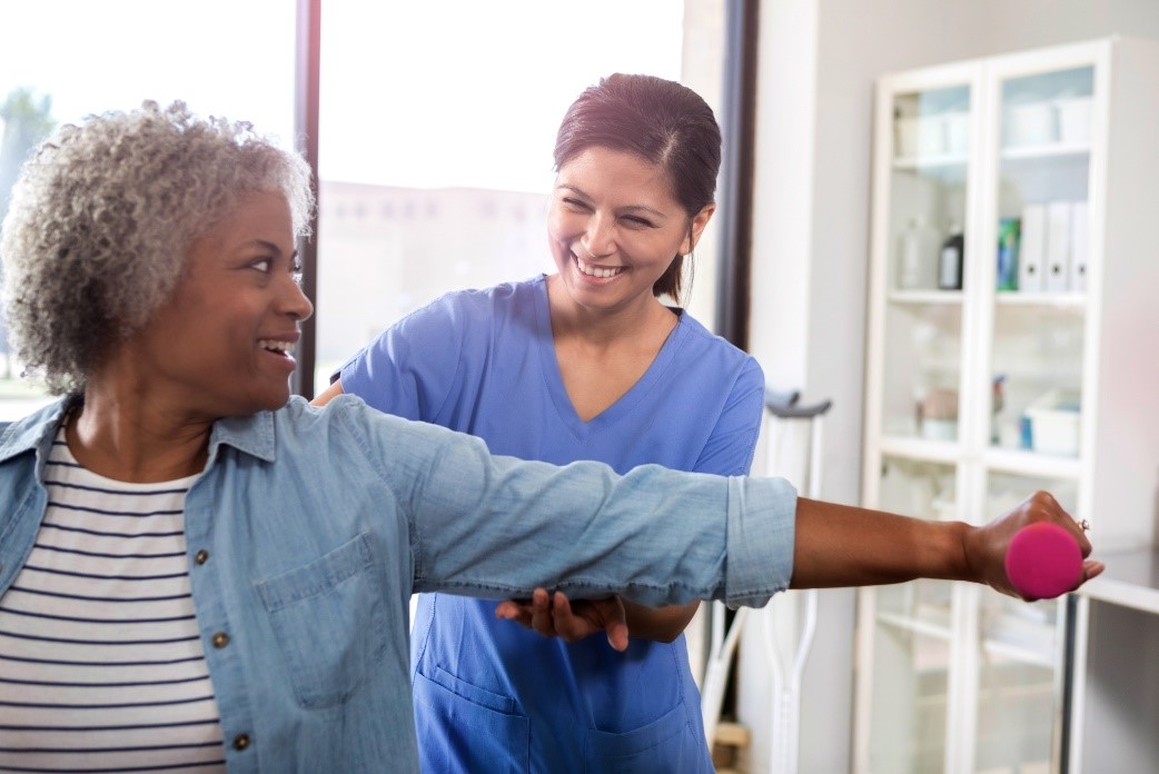 Physical therapist taking care of the elderly woman